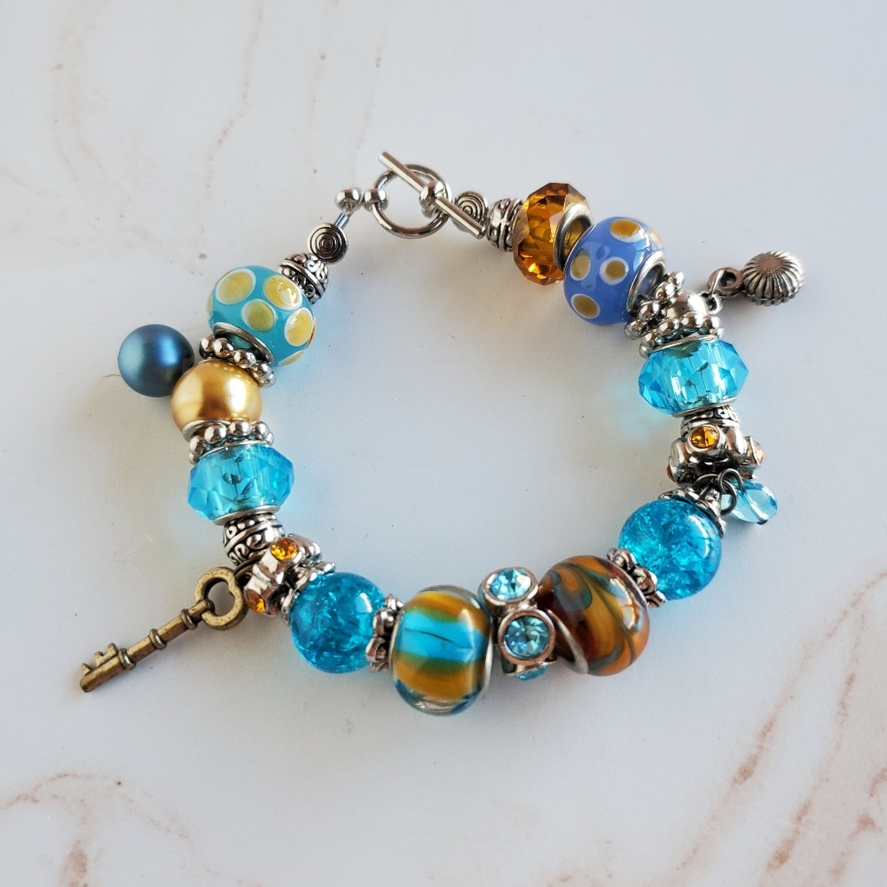 Beaded crystals rhinestones and findings blue tan charm bracelet silver tone